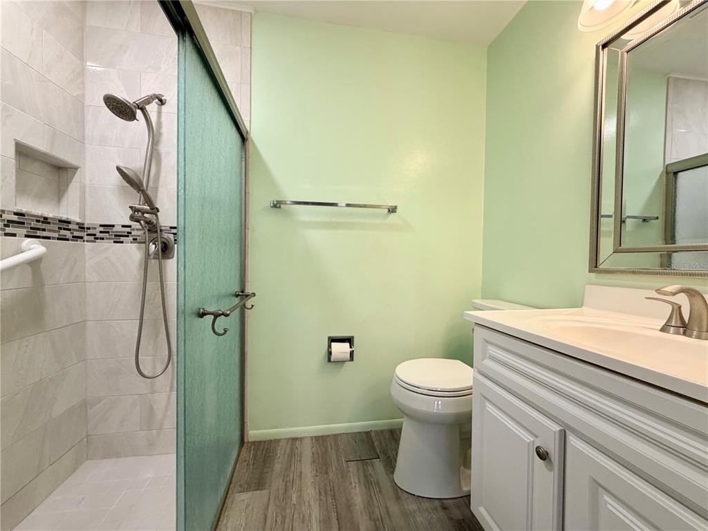 11210 Dollar Lake Drive, Unit 2 Port Richey, FL 34668 - Photo 8 of 15 a bathroom with a sink a toilet and shower