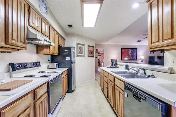 a kitchen with stainless steel appliances granite countertop a sink stove and cabinets