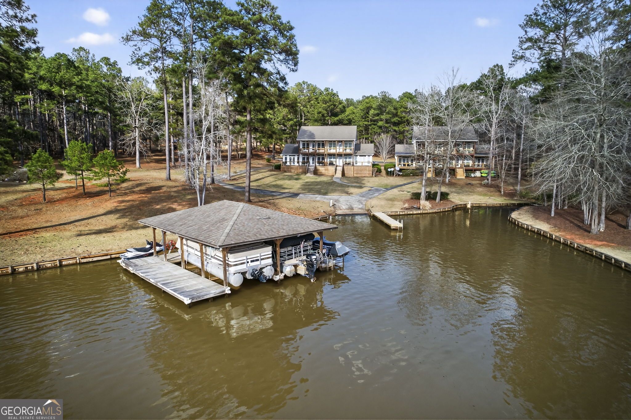 655 Sandy Run Drive, Unit 4 Sparta, GA 31087 - Photo 14 of 59 a view of a lake with boats and trees all around