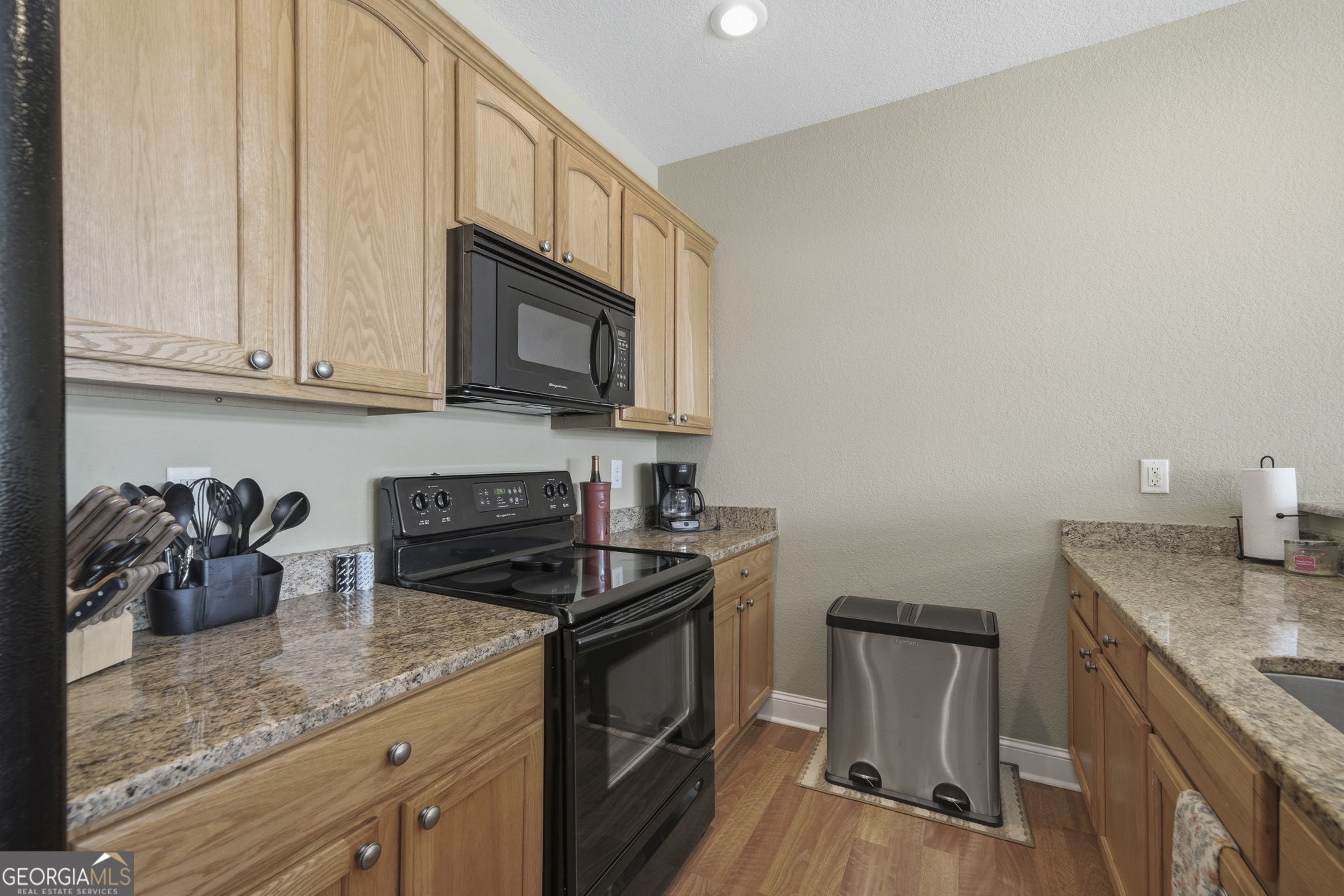 655 Sandy Run Drive, Unit 4 Sparta, GA 31087 - Photo 30 of 59 a kitchen with granite countertop a sink a stove and cabinets