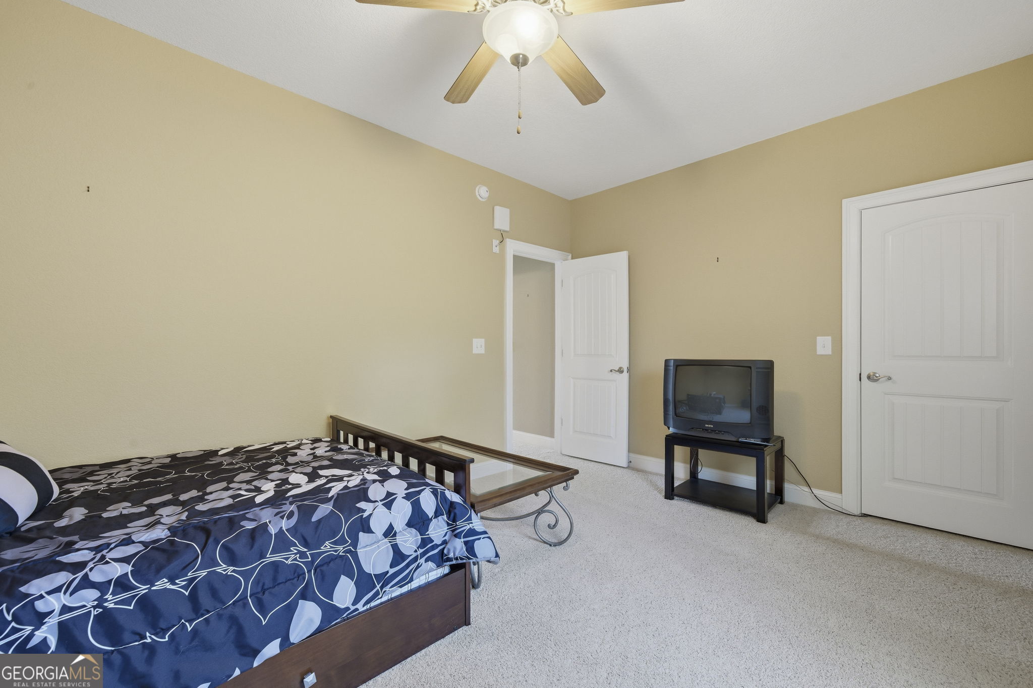 655 Sandy Run Drive, Unit 4 Sparta, GA 31087 - Photo 49 of 59 a bedroom with a bed and a chandelier