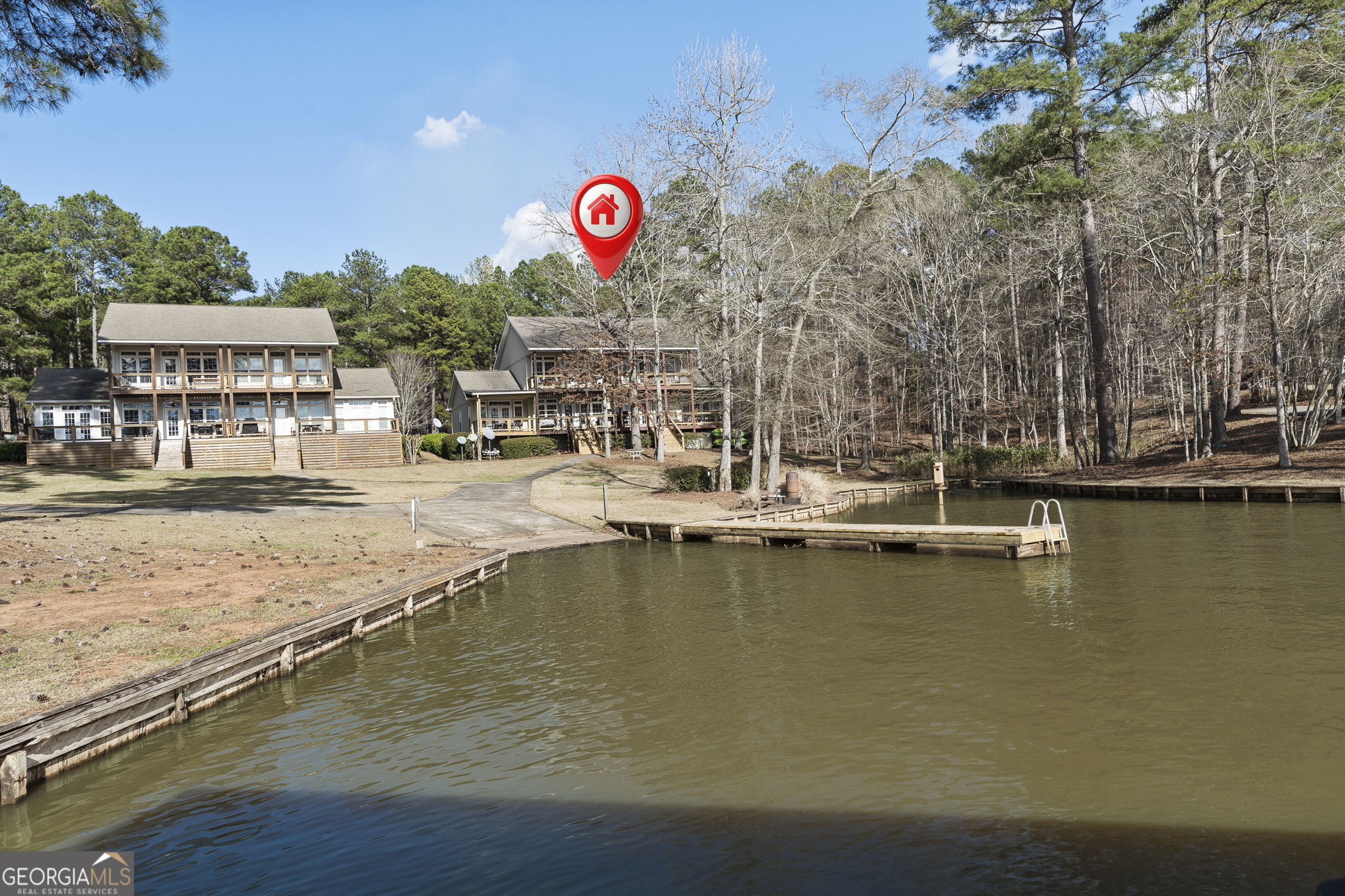 655 Sandy Run Drive, Unit 4 Sparta, GA 31087 - Photo 57 of 59 a view of a water with a table and chairs under an umbrella