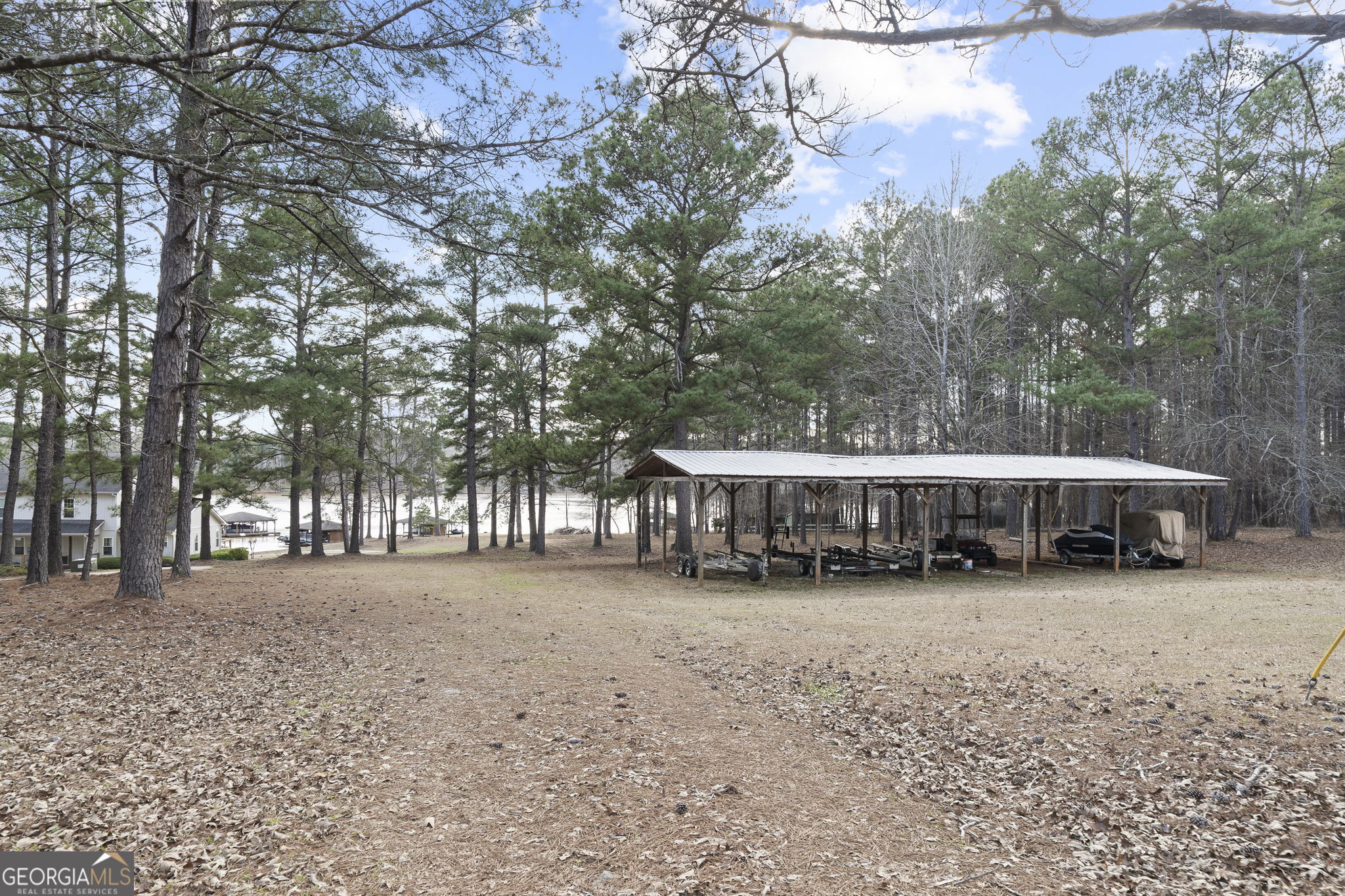 655 Sandy Run Drive, Unit 4 Sparta, GA 31087 - Photo 59 of 59 a view of a house with large trees and wooden fence