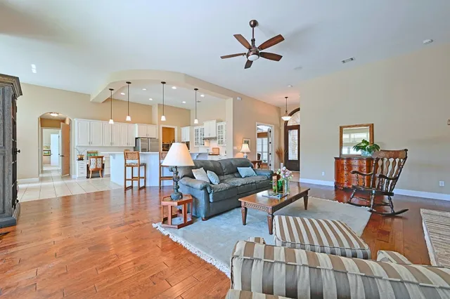 a living room with furniture and kitchen view