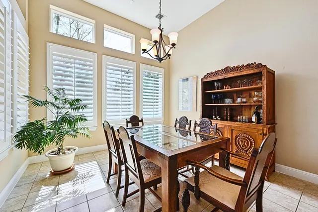 a view of a dining room with furniture and a window