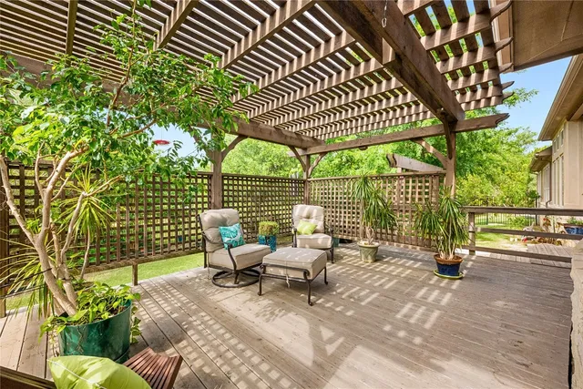 a living room with patio furniture and a floor to ceiling window