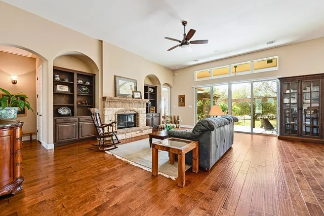 a living room with furniture fireplace and a large window