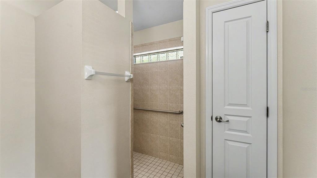 8525 North Campbell Road Lakeland, FL 33810 - Photo 18 of 45 a bathroom with a glass shower door