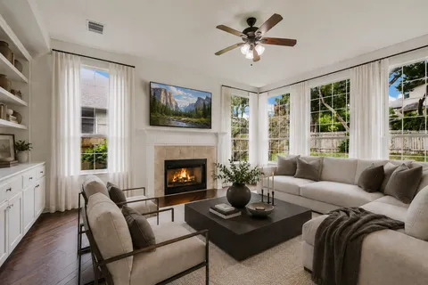 a living room with furniture fireplace and window