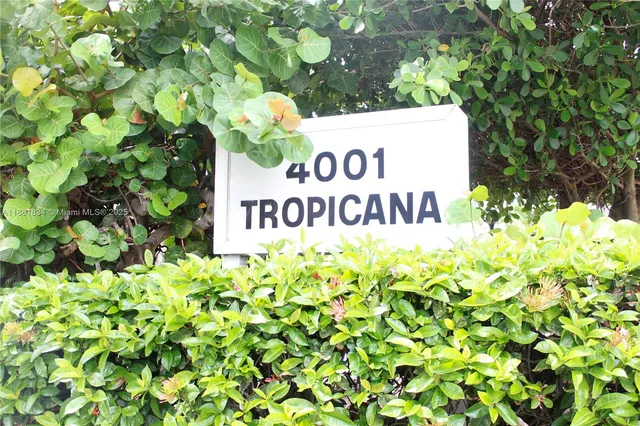 a sign that is sitting in front of flowers