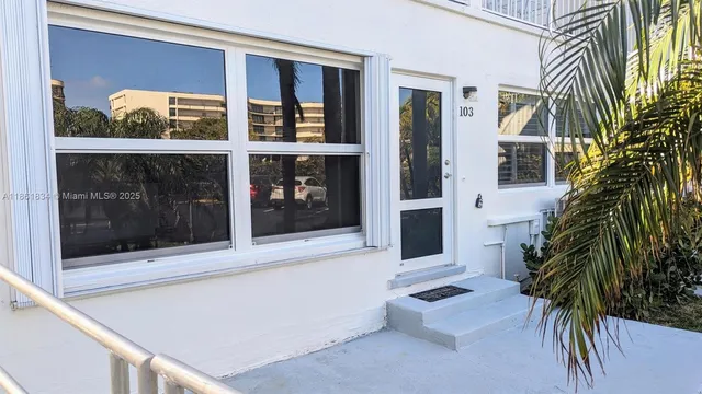 a view of front door and potted plants
