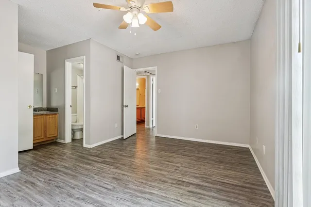 a view of an empty room with wooden floor
