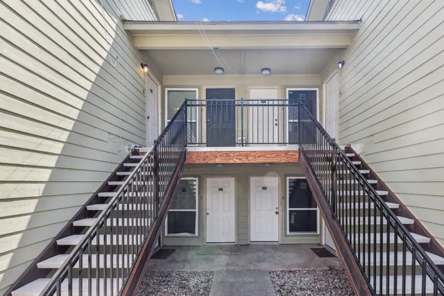 a view of a balcony with stairs and wooden floor