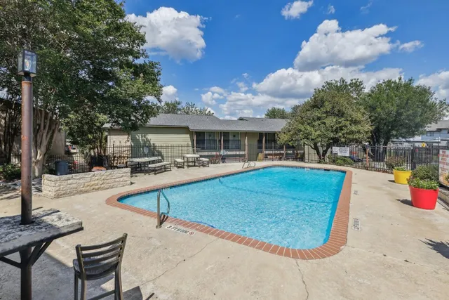 a view of a house with swimming pool and sitting area