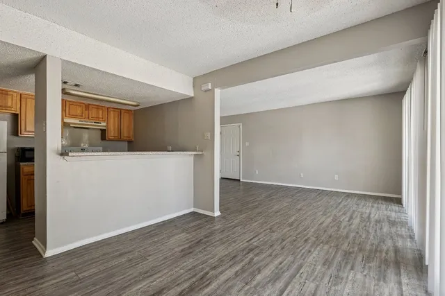 a view of a kitchen with wooden floor and electronic appliances