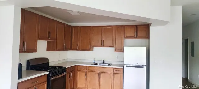 a kitchen with a sink a stove and cabinets