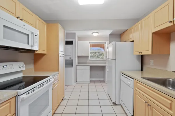 a kitchen with a stove top oven and cabinets