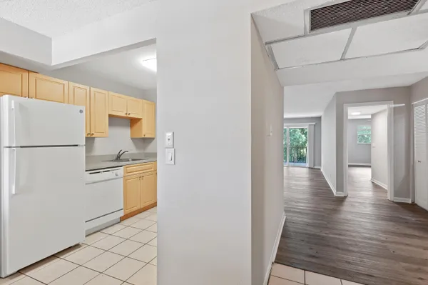 a kitchen with a refrigerator and a stove