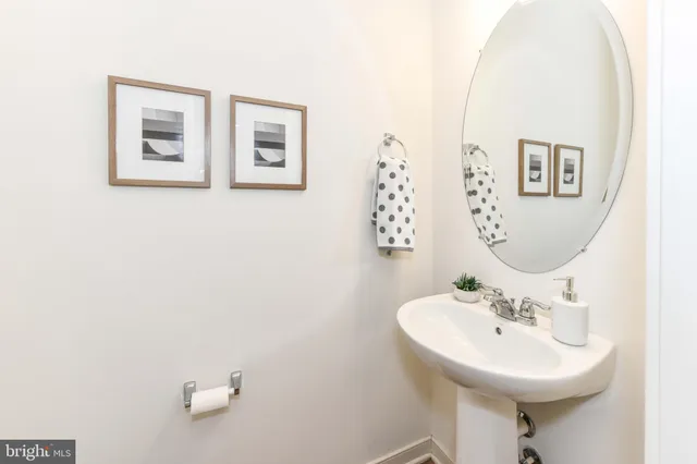 a bathroom with a sink mirror and toilet
