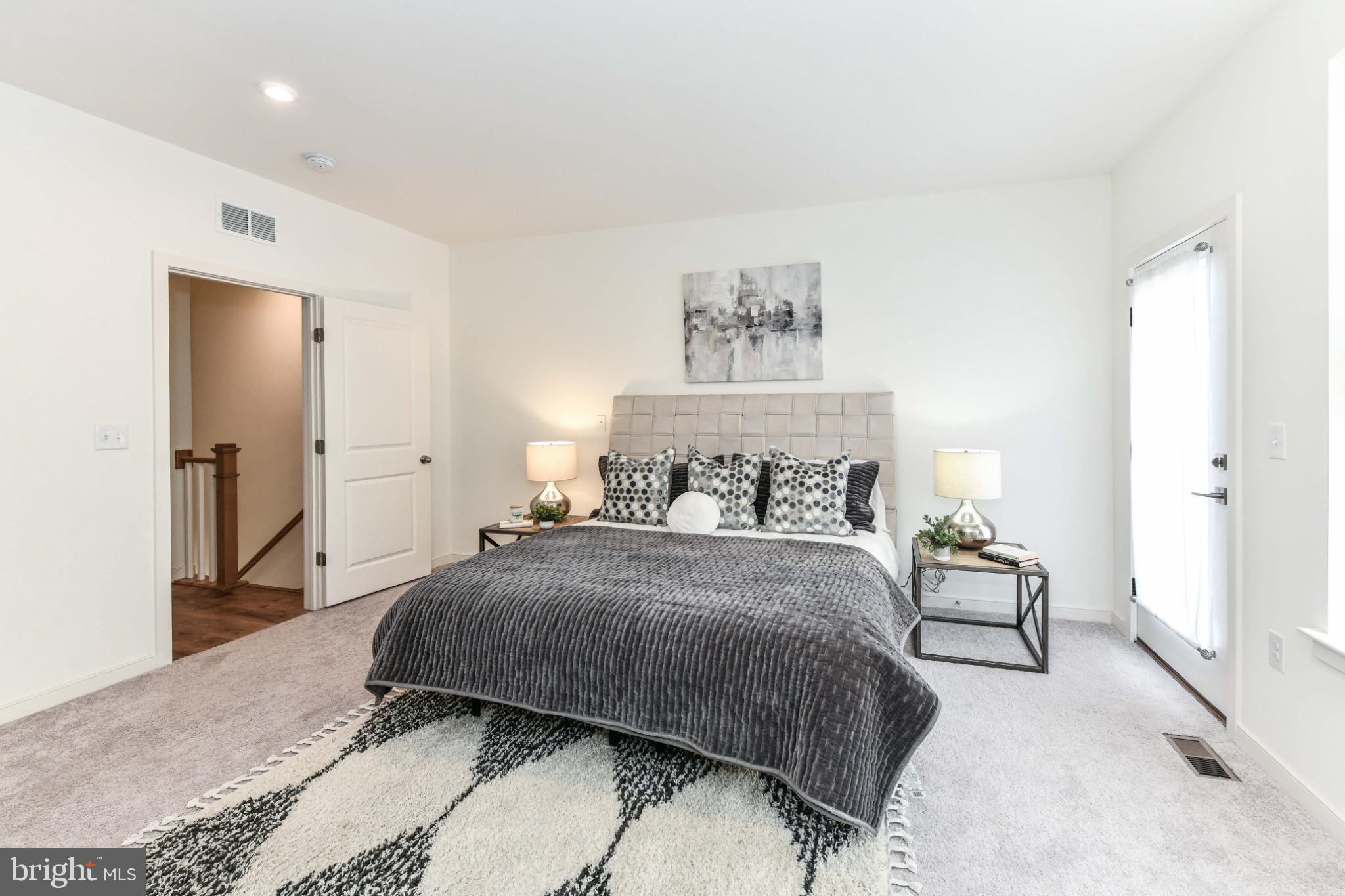 45922 Swallow Terrace Sterling, VA 20165 - Photo 18 of 36 a bedroom with a bed and a painting on the wall