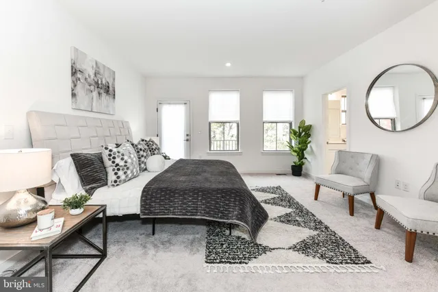 a living room with furniture a rug and a mirror