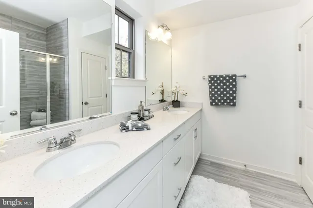 a bathroom with a double vanity sink and a mirror