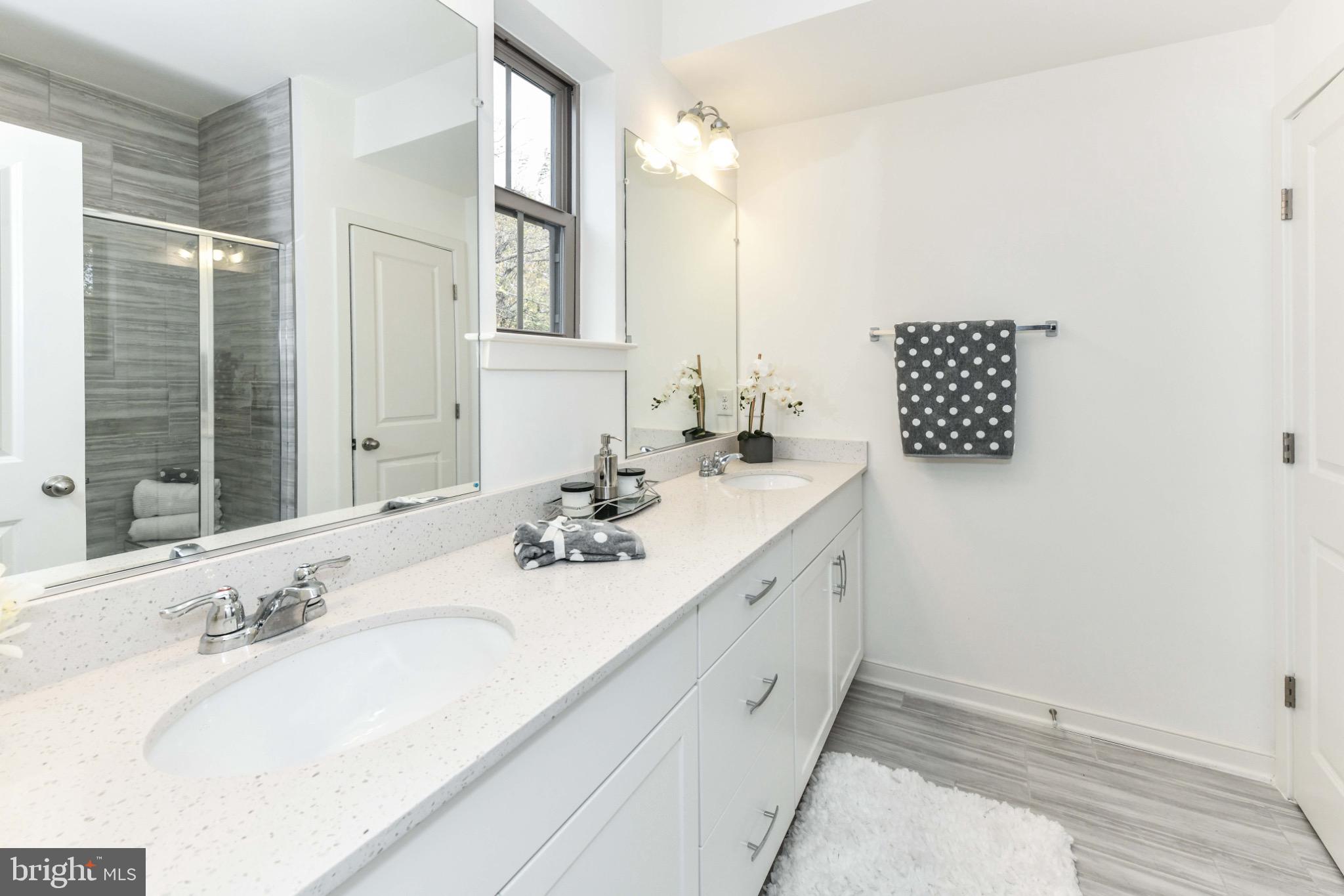 45922 Swallow Terrace Sterling, VA 20165 - Photo 23 of 36 a bathroom with a double vanity sink and a mirror