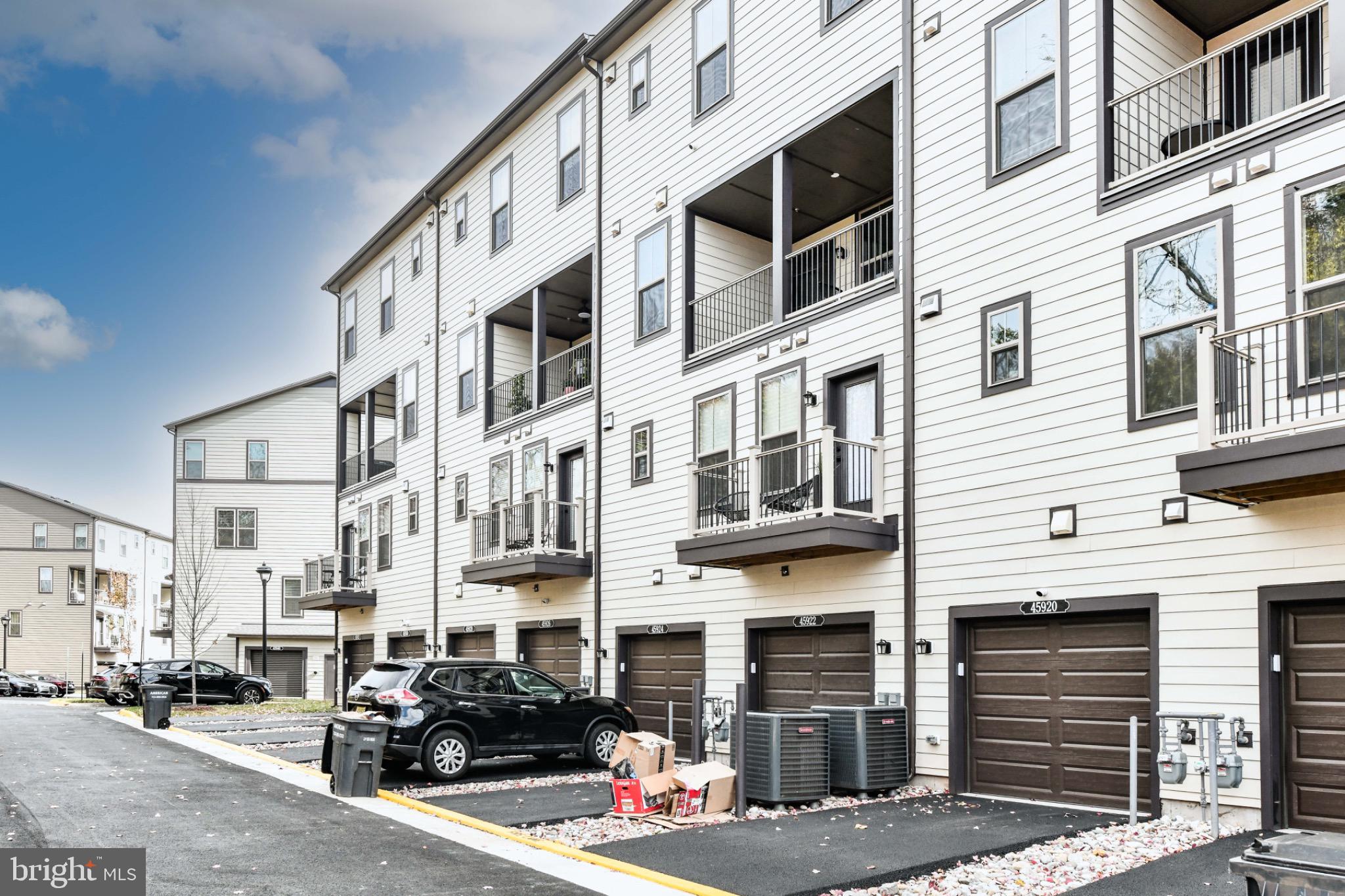 45922 Swallow Terrace Sterling, VA 20165 - Photo 31 of 36 a city street lined with tall buildings and cars parked