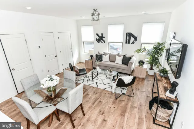 a living room with furniture and a wooden floor