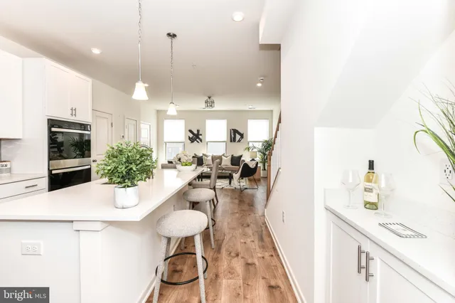 a kitchen with stainless steel appliances kitchen island granite countertop a sink and a refrigerator