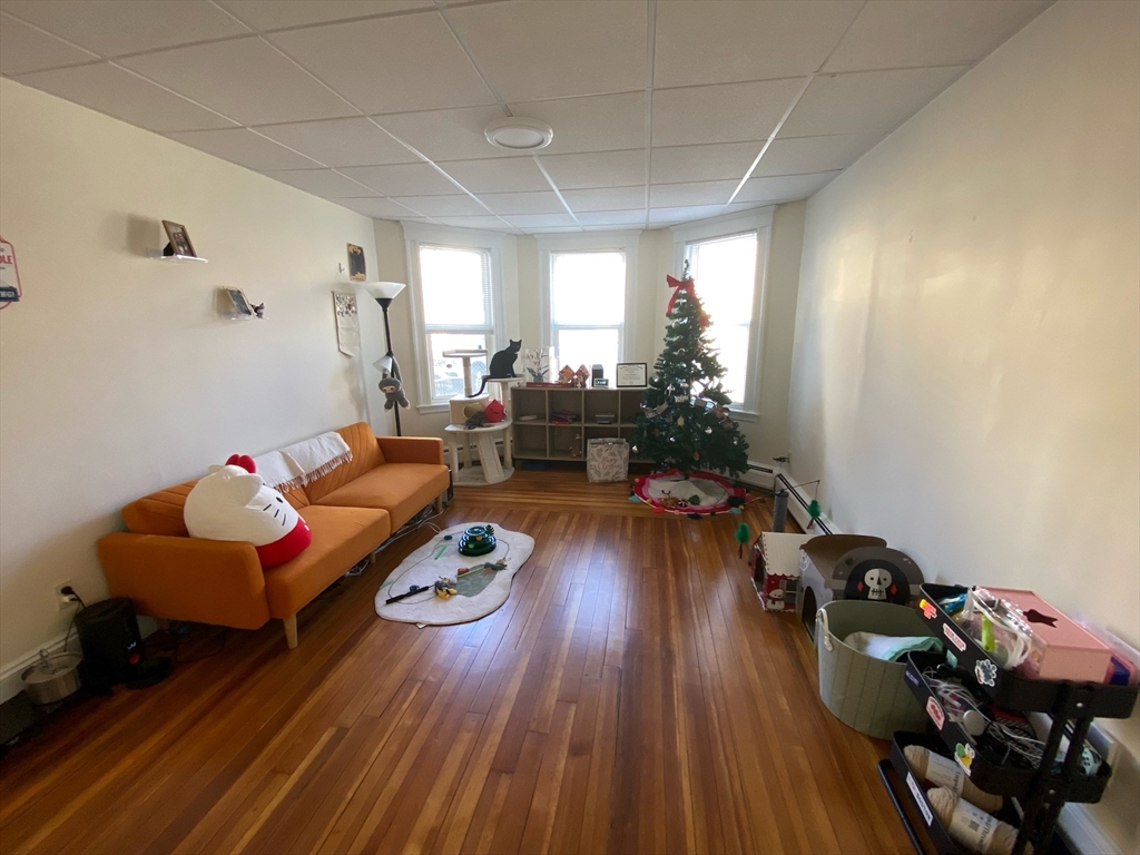 112 Thurston Street, Unit 1 Somerville, MA 02145 - Photo 4 of 7 a living room with furniture and a wooden floor