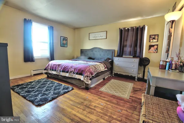 a bedroom with bed and a window