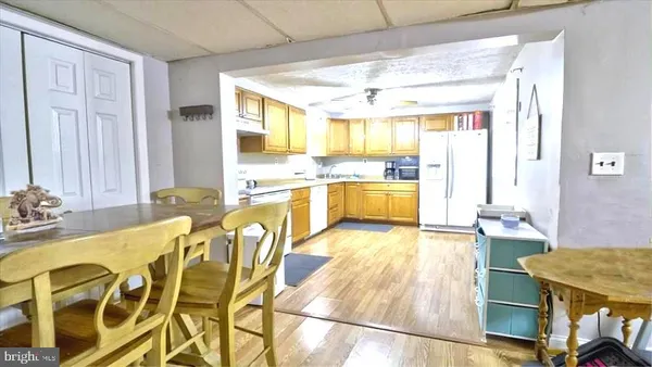 a large kitchen with kitchen island a large window in it