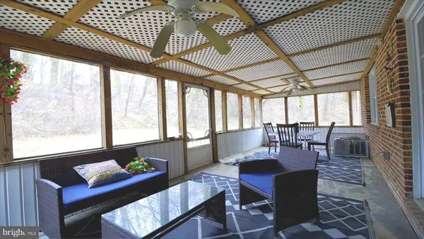 a dining room with furniture a rug and wooden floor