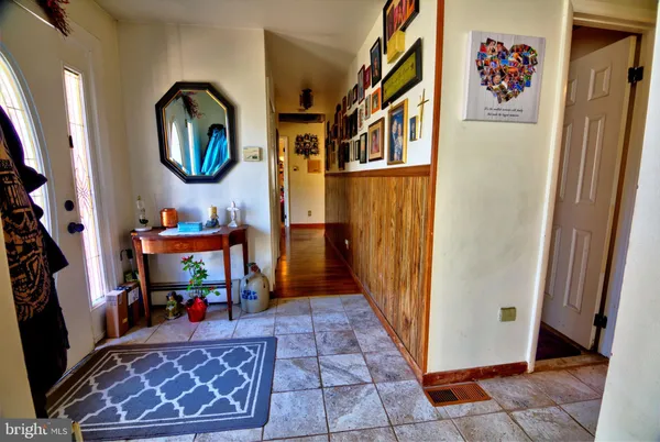 a view of a hallway with entryway wooden floor and front door