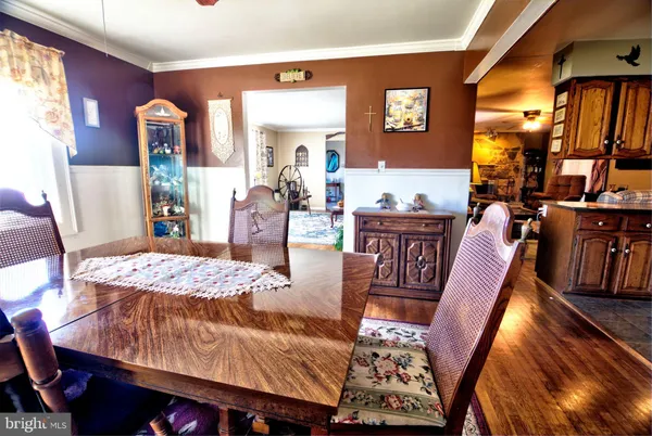 a dining room with furniture and wooden floor