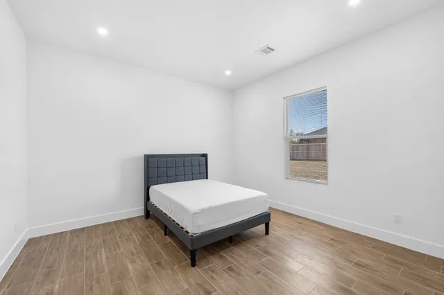 a view of a room with wooden floor