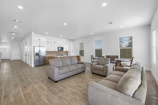 a living room with furniture and kitchen view