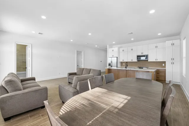 a living room with furniture and kitchen view
