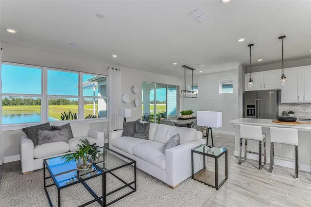 a living room with furniture and a large window