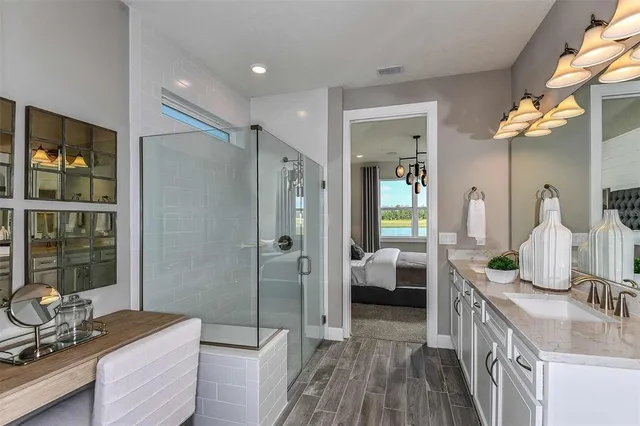 a bathroom with a double vanity sink a mirror and shower