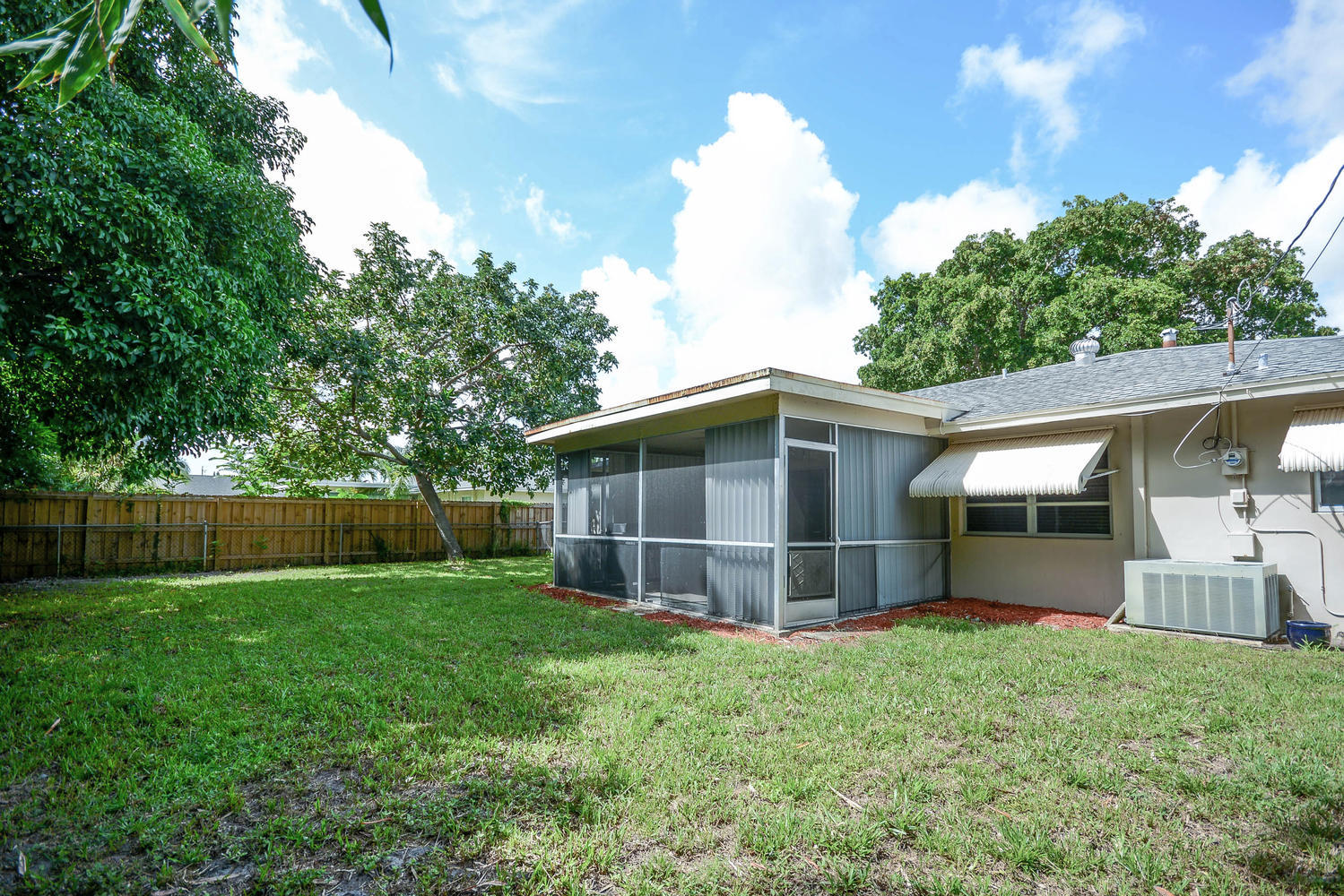 493 Dover Road Tequesta, FL 33469 - Photo 31 of 33 a front view of a house with a yard and potted plants