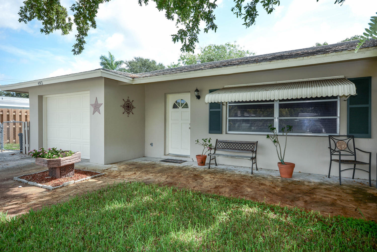 493 Dover Road Tequesta, FL 33469 - Photo 10 of 33 a backyard of a house with barbeque oven fire pit table and chairs