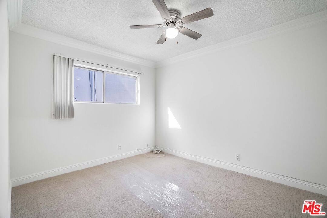 7548 Hampton Avenue, Unit 304 West Hollywood, CA 90046 - Photo 14 of 23 an empty room with a window and a fan