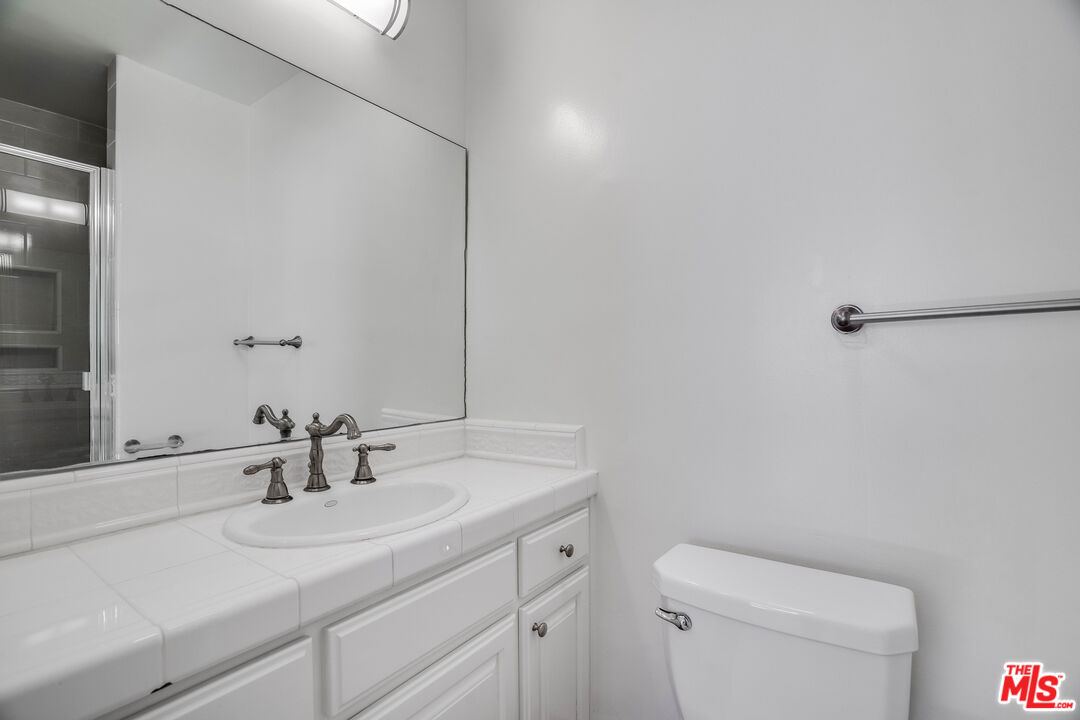 7548 Hampton Avenue, Unit 304 West Hollywood, CA 90046 - Photo 17 of 23 a bathroom with a sink and a toilet