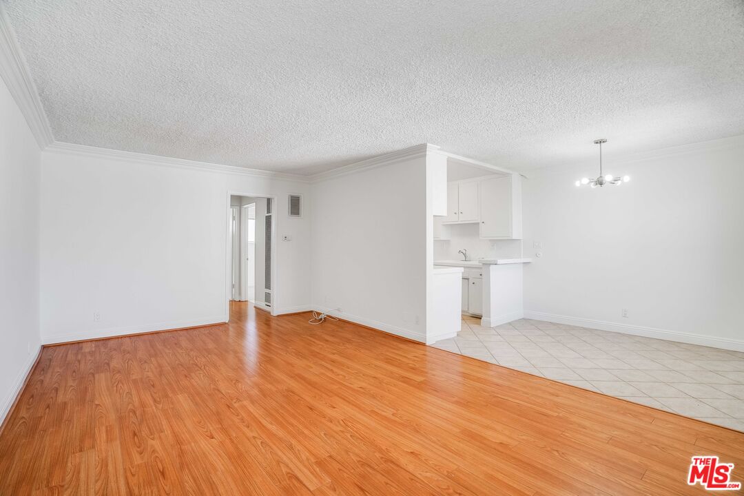 7548 Hampton Avenue, Unit 304 West Hollywood, CA 90046 - Photo 3 of 23 a view of empty room with wooden floor