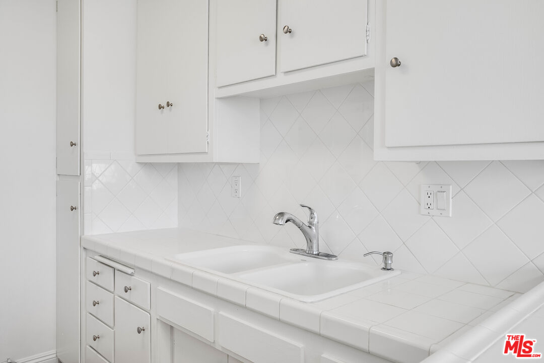 7548 Hampton Avenue, Unit 304 West Hollywood, CA 90046 - Photo 6 of 23 a bathroom with a sink and cabinets