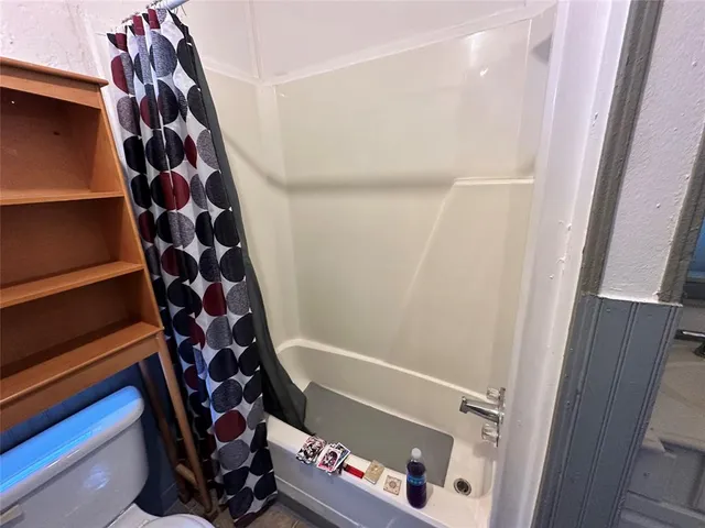 a bedroom with furniture and a chandelier