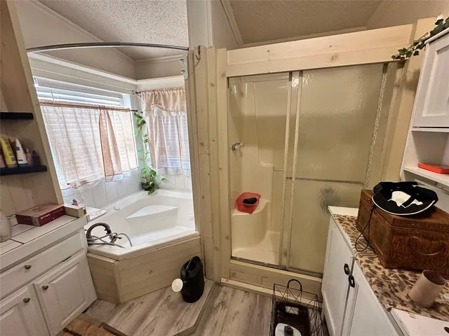 a bathroom with a sink vanity tub and a mirror