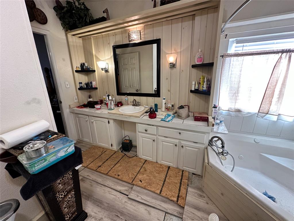 13925 Briar Road Azle, TX 76020 - Photo 20 of 22 a bathroom with a sink vanity tub and a mirror